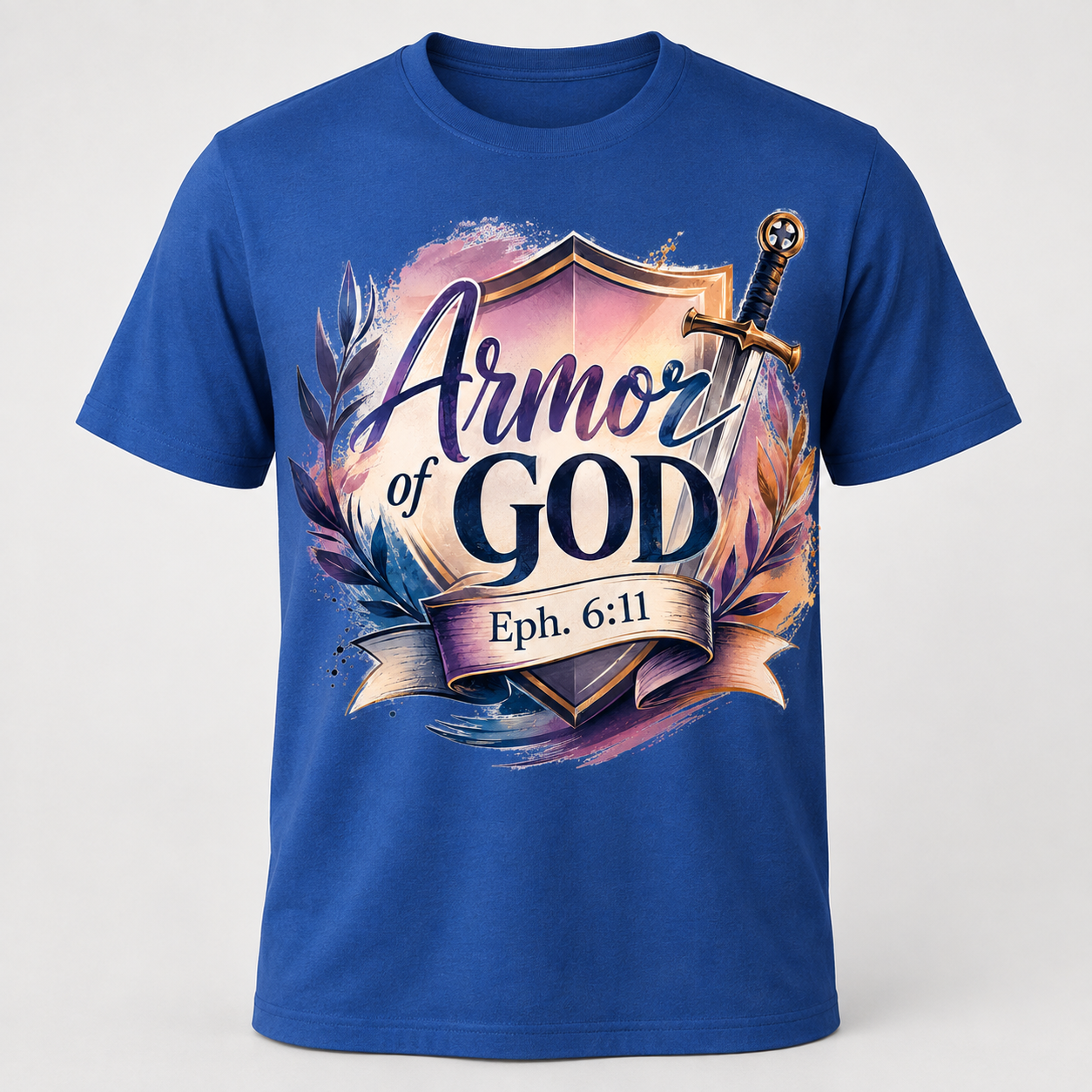 A royal blue short-sleeve crewneck t-shirt featuring a graphic design on the front with the text 'Armor of GOD Eph. 6:11' inside a shield, decorated with a sword, laurel leaves, and a purple and gold watercolor background.
