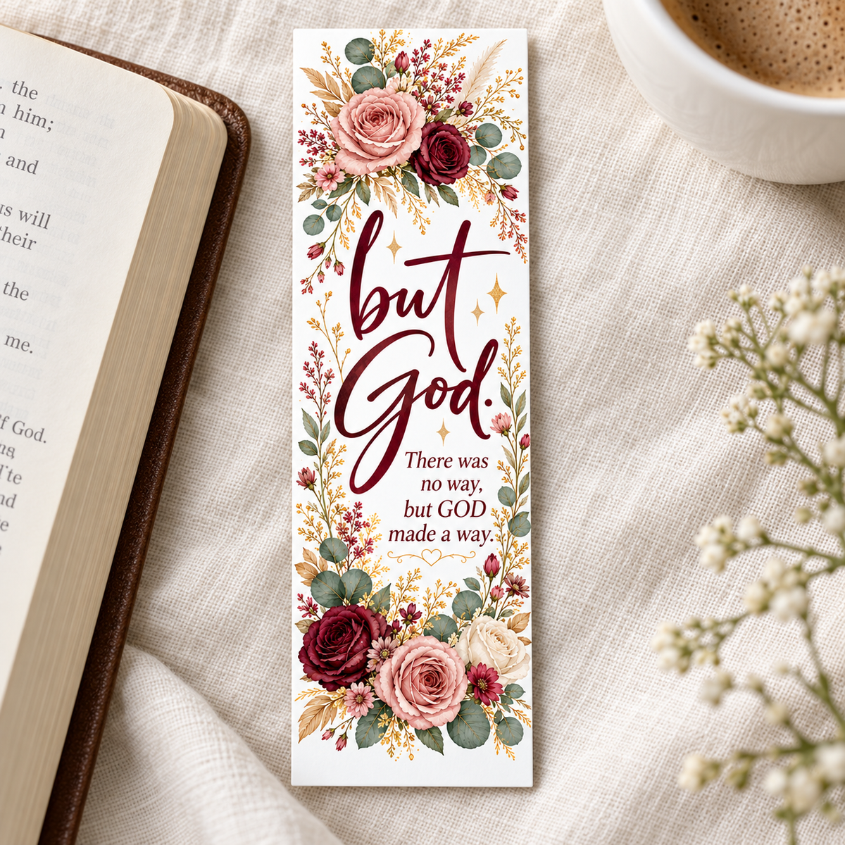 But God floral bookmark with burgundy lettering and blush, cream, and burgundy roses, displayed beside an open book and a cup of coffee.