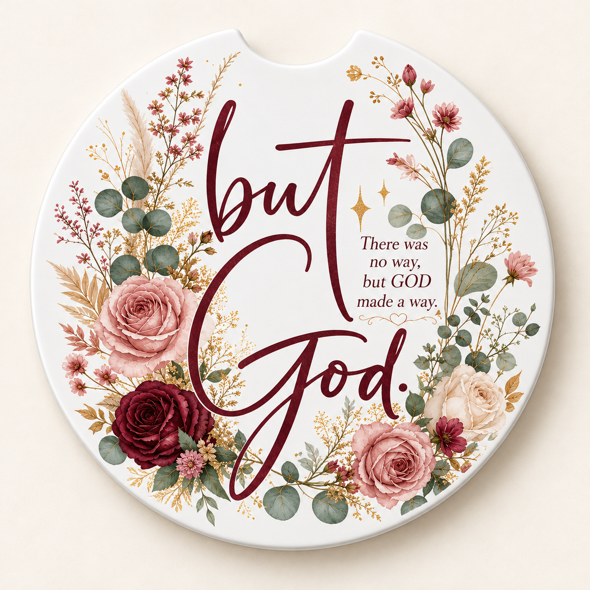 Round white car coaster with a finger notch, burgundy But God lettering, blush and cream roses, sage greenery, and an encouraging faith message.