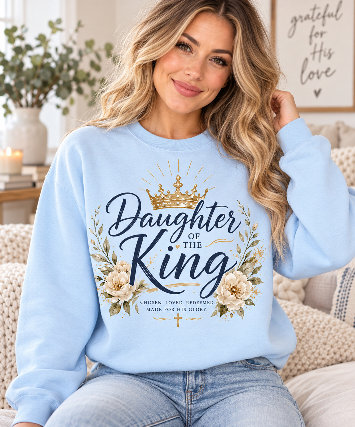Light blue Daughter of the King Christian sweatshirt featuring navy lettering, gold crown, floral accents, and Chosen Loved Redeemed Made for His Glory.