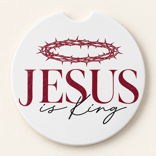 Round white car coaster with a finger notch featuring a burgundy crown of thorns above burgundy JESUS lettering and black is King script.