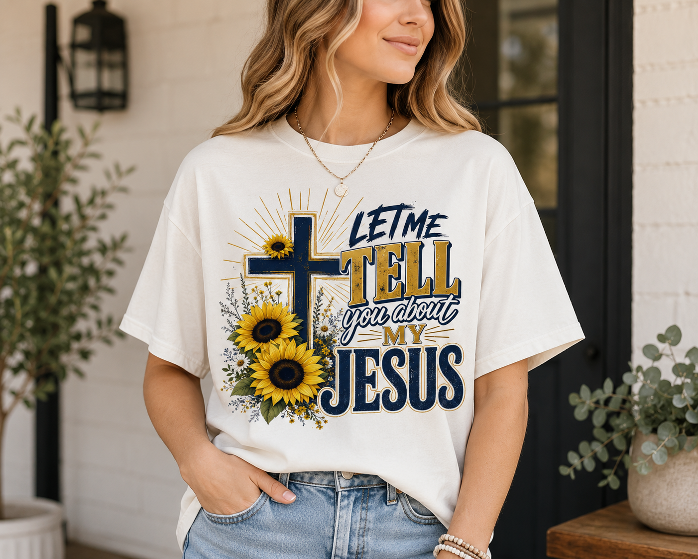 Woman wearing a white Let Me Tell You About My Jesus Christian T-shirt featuring a navy and gold cross with yellow sunflowers and bold faith-based typography.