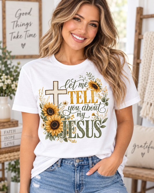 White Christian T-shirt featuring “Let Me Tell You About My Jesus” with a cross, golden sunflowers, wildflowers, and green botanical accents.